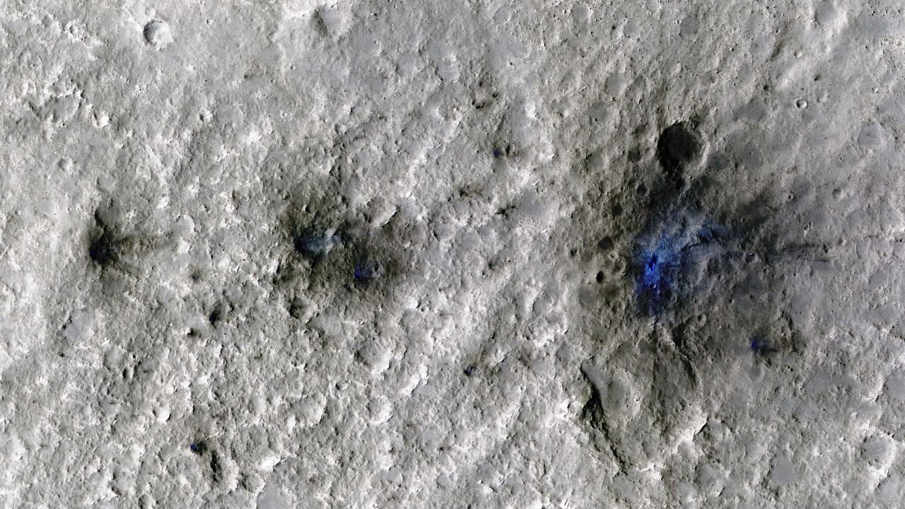 Craters formed by a September 5, 2021, meteoroid impact on Mars, the first to be detected by NASAÕs InSight, are seen in an image taken by NASAÕs Mars Reconnaissance Orbiter. Credit: Reuters Photo