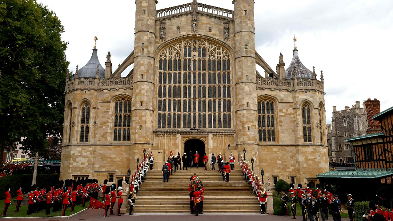 Pall bearers carry the coffin of Queen Elizabeth II with the Imperial State Crown resting on top into St. George's Chapel at Windsor Castle on September 19, 2022. Credit: AFP Photo