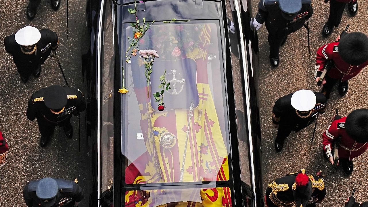 Flowers lay on the roof of the State Hearse carrying the coffin of Queen Elizabeth II. Credit: AFP Photo