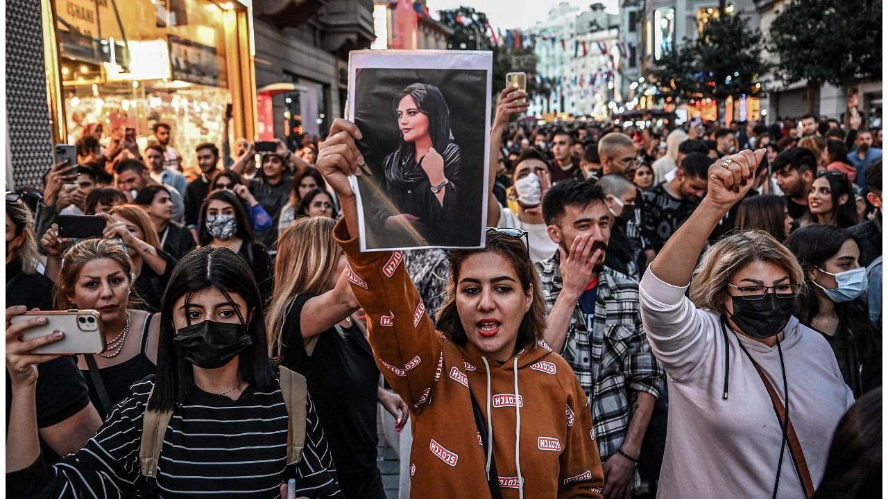 A protester holds a portrait of Mahsa Amini during a demonstration in support of Amini, a young Iranian woman who died after being arrested in Tehran by the Islamic Republic's morality police. Credit: Reuters Photo