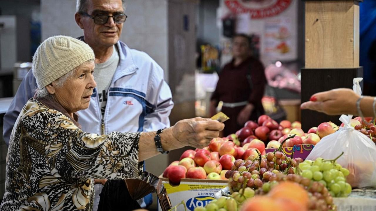 An elderly couple buys fruits at a local market in Kryvyj Rih. Credit: AFP Photo