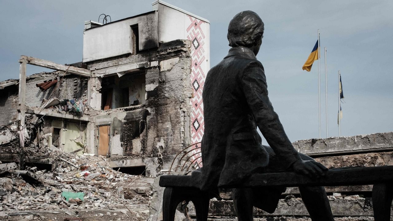 A statue of Ukrainian poet, writer and artist Taras Shevchenko is seen in front of the destroyed building of the Palace of Culture in the retaken city of Derhachi, Kharkiv. Credit: AFP Photo