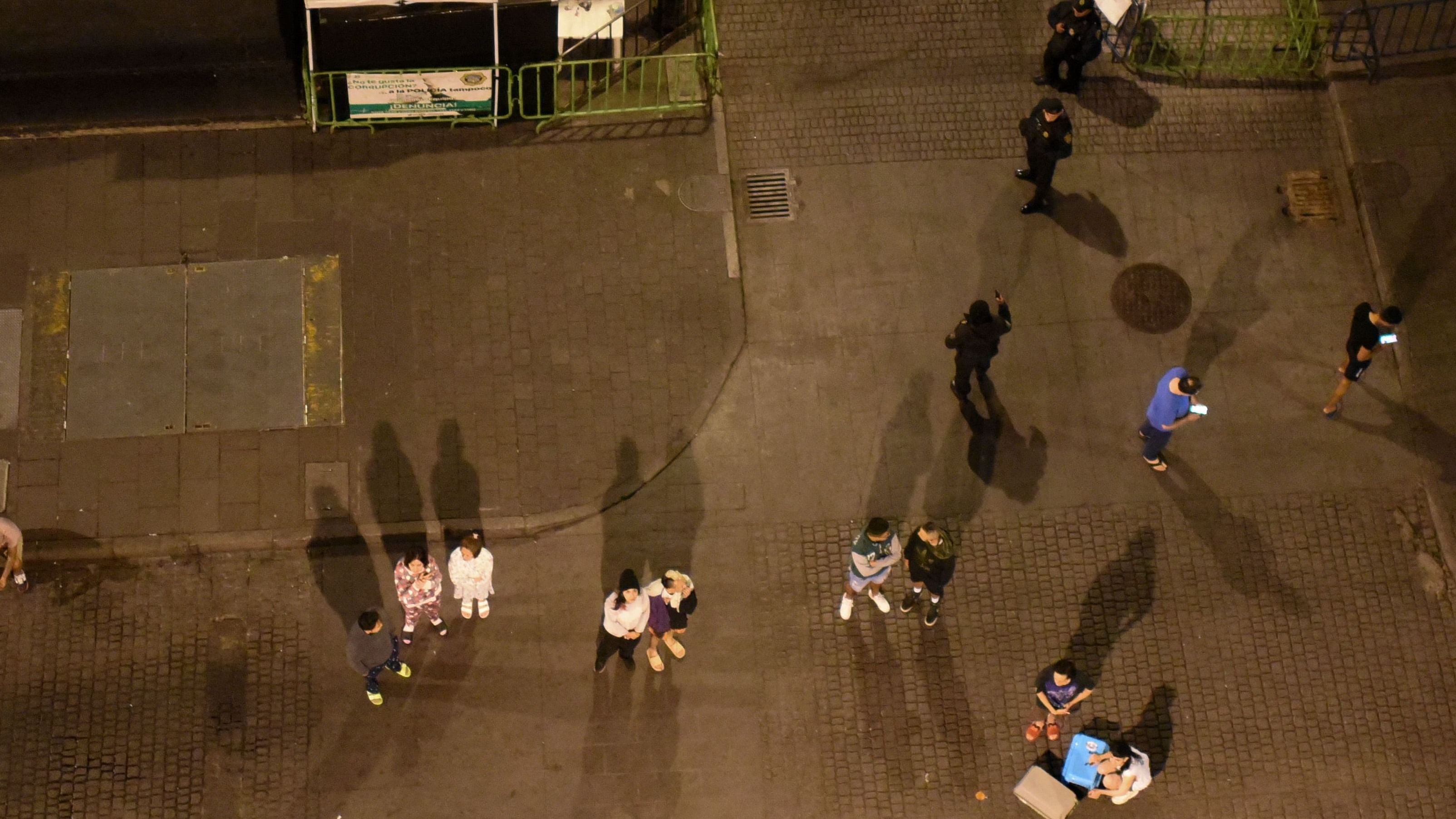 Residents stand in a street after a 6.8-magnitude earthquake in Mexico City on September 22. Credit: AFP Photo