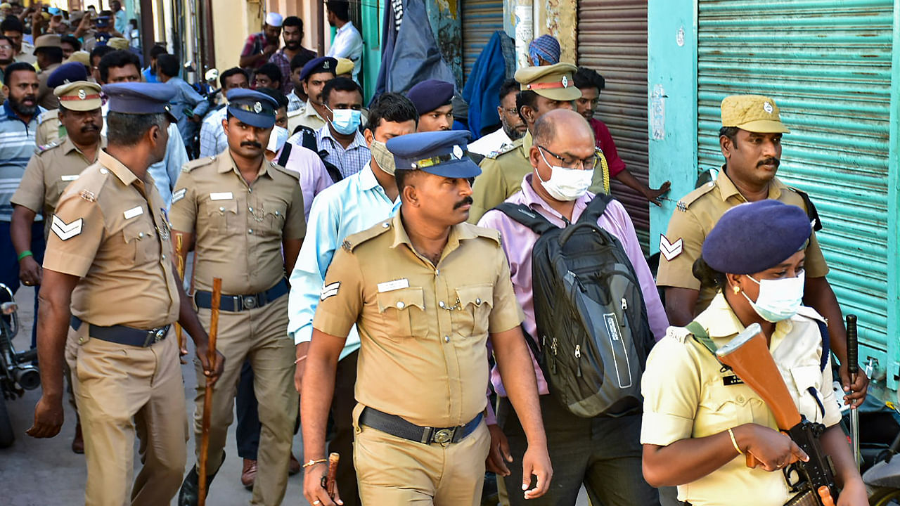 Officers of National Investigation Agency (NIA) with police personnel during a raid at the residence of a functionary of Popular Front of India (PFI), in Madurai. Credit: PTI Photo