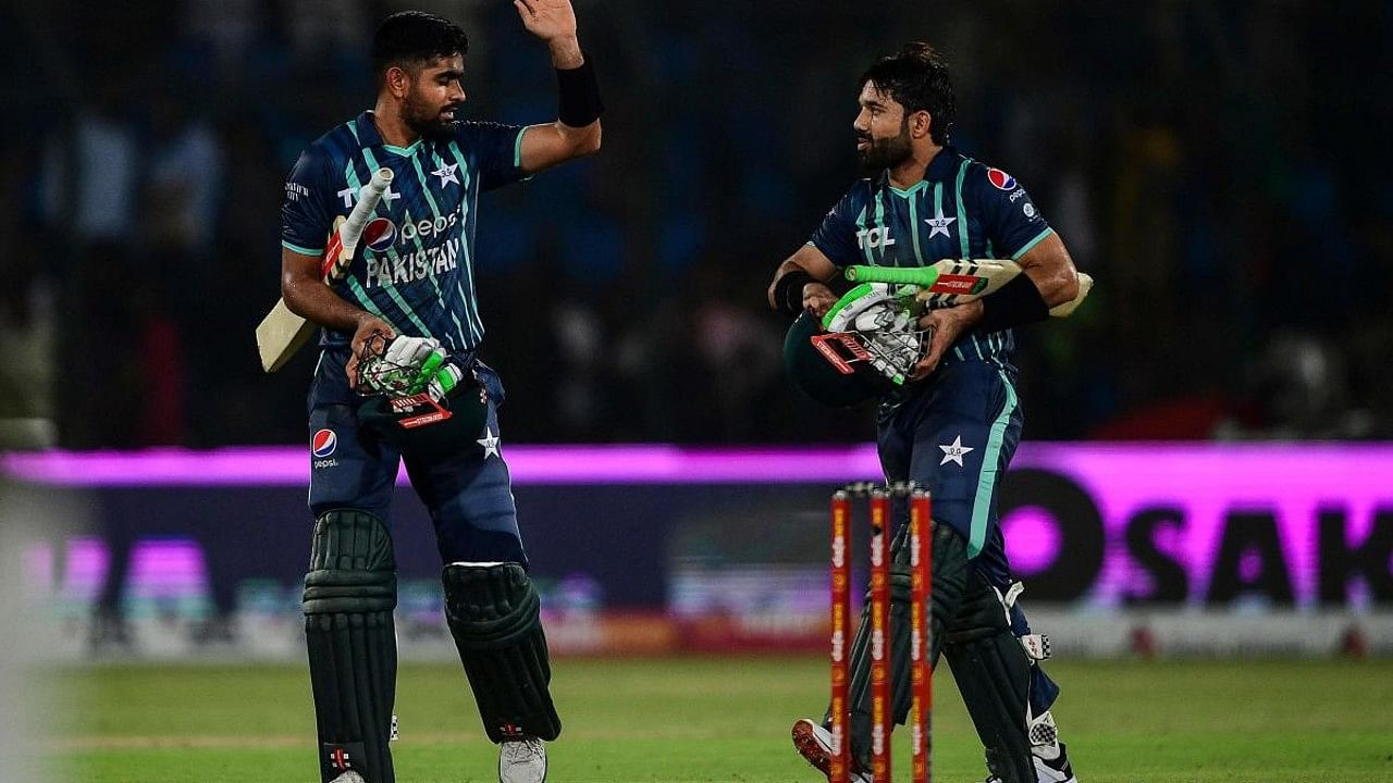 Pakistan's captain Babar Azam (L) and teammate Mohammad Rizwan celebrate after their win at the end of the second Twenty20 international cricket match between Pakistan and England. Credit: AFP Photo