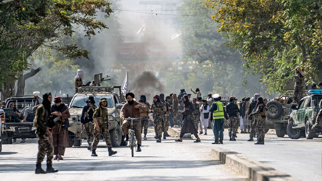 Taliban fighters stand guard at the explosion site, near a mosque, in Kabul, Afghanistan, Friday, Sept. 23, 2022. Credit: AP/PTI Photo