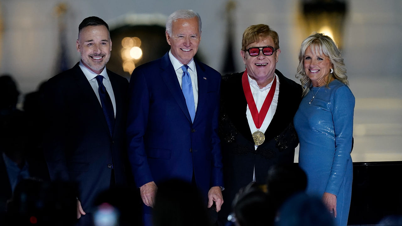 David Furnish, husband of Elton John, left, Elton John, President Joe Biden and first lady Jill Biden pose for a photo after Biden presented Elton John with a National Humanities Medal after a concert on the South Lawn of the White House in Washington. Credit: AP Photo