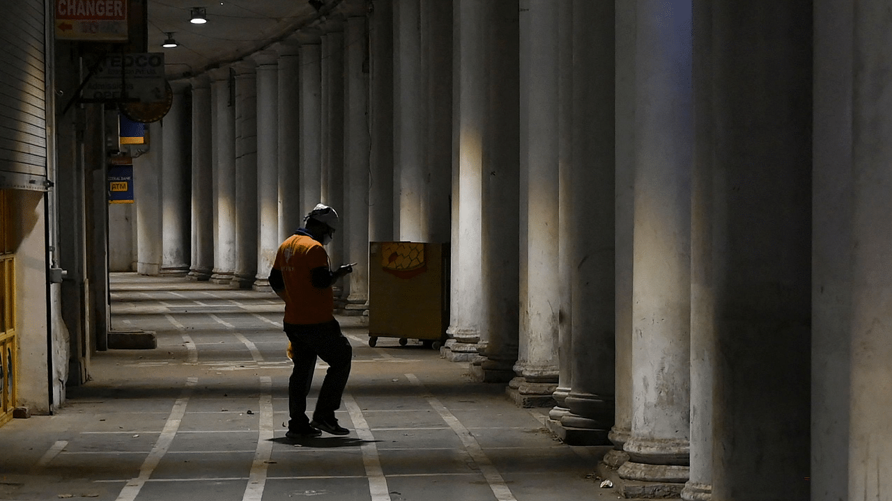 A food delivery assistant stands in front of food outlet in New Delhi. Credit: AFP File Photo