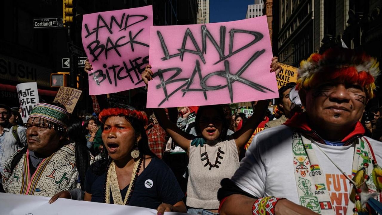 Indigenous community members join activists during a rally organized by youth climate awareness group Fridays for Future to declare a 'climate justice emergency' in New York city on September 23, 2022. Credit: AFP Photo