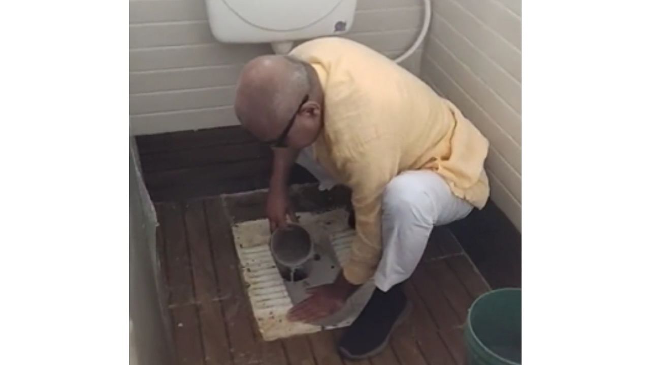BJP MP from Madhya Pradesh's Rewa, Janardan Mishra seen cleaning the toilet of a girls' school in his constituency with his bare hands. Credit: Video screengrab from Twitter/@Janardan_BJP