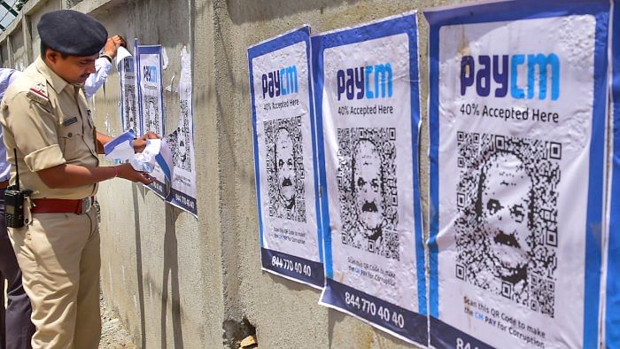 The Congress launched the PayCM campaign, putting out posters in public places with a QR code with a visible image of Bommai in the middle. Credit: PTI