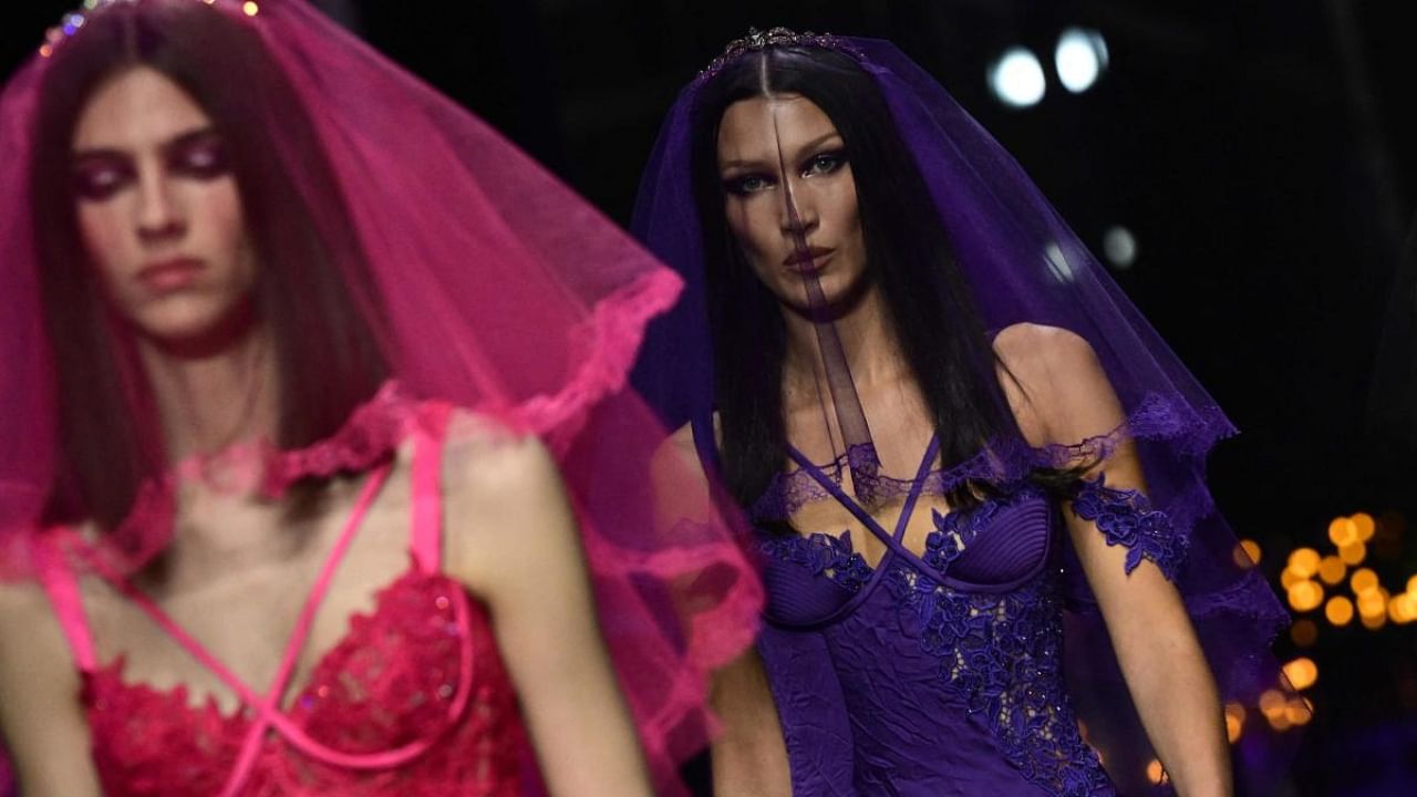 US model Bella Hadid (R) presents a creation for Versace's Women's Spring Summer 2023 fashion collection as part of the Fashion Week in Milan. Credit: AFP Photo
