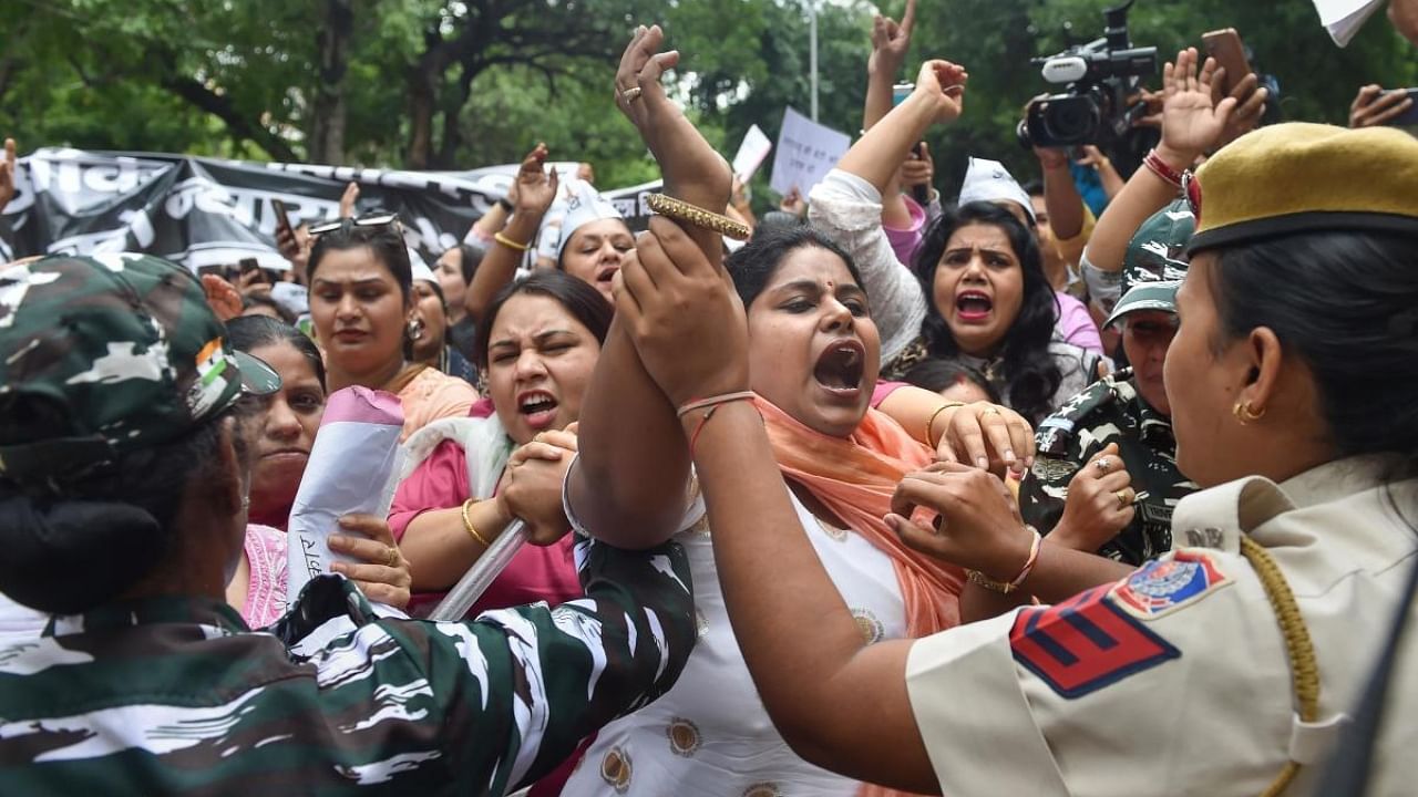 Security personnel try to disperse members of AAP women wing protesting against BJP over the killing of Ankita Bhandari. Credit: PTI Photo