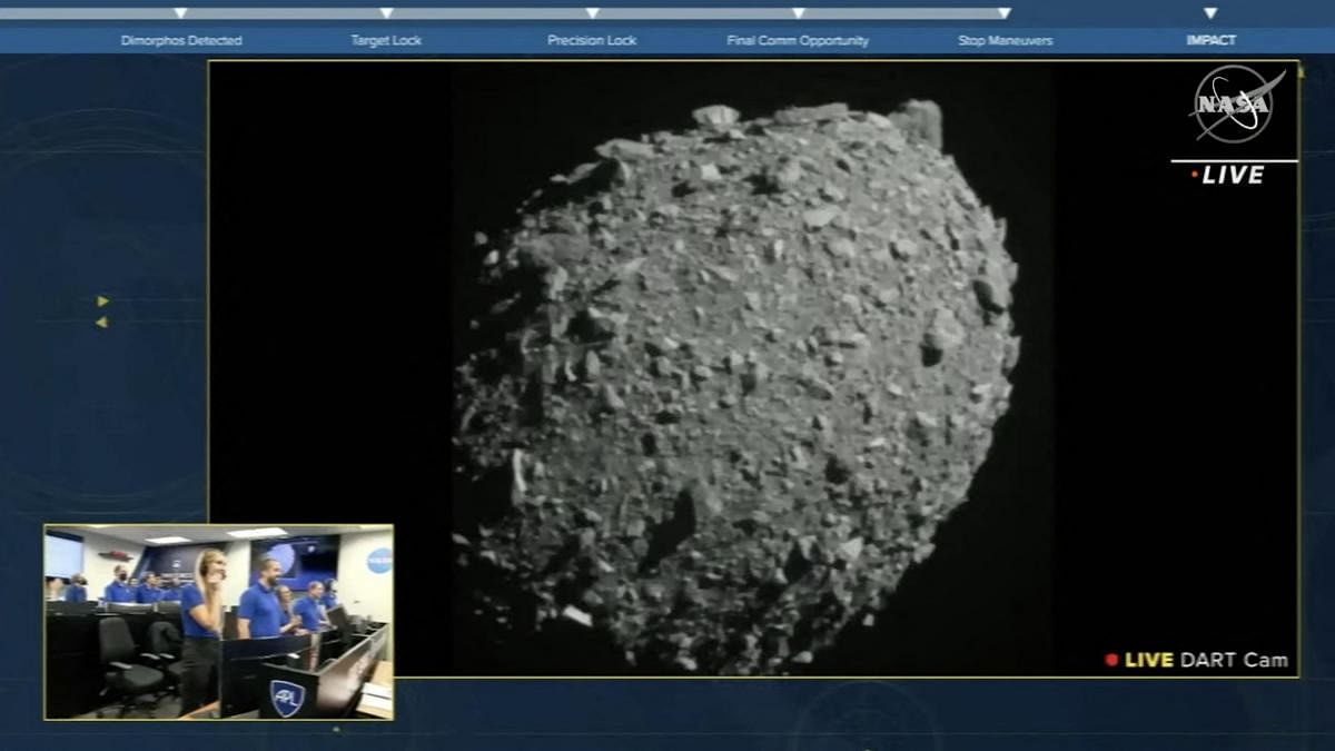 This screengrab made from NASA live feed on September 26, 2022, shows Dimorphos just before the Double Asteroid Redirection Test (DART) made impact with the asteroid, as watched by the NASA team (bottom L) at DART headquarters in Laurel. Credit: AFP Photo/NASA
