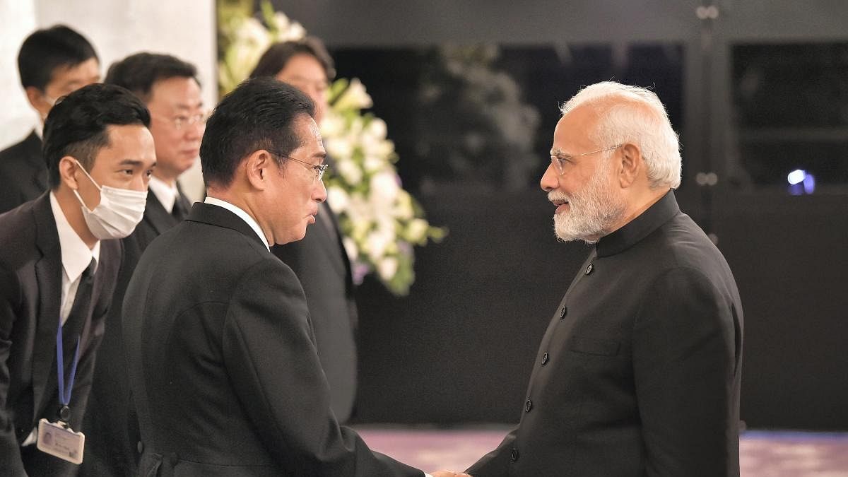 Japan's Prime Minister Fumio Kishida, left welcomes India's Prime Minister Narendra Modi to a reception at the Akasaka Palace state guest house. Credit: AP/PTI Photo