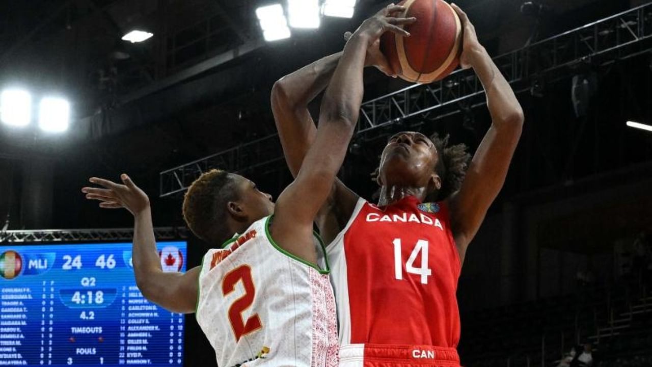 Canada's Kayla Alexander (R) and Mali's Salimatou Kourouma struggle for possession during the Women's Basketball World Cup group B game between Canada and Mali in Sydney. Credit: AFP Photo