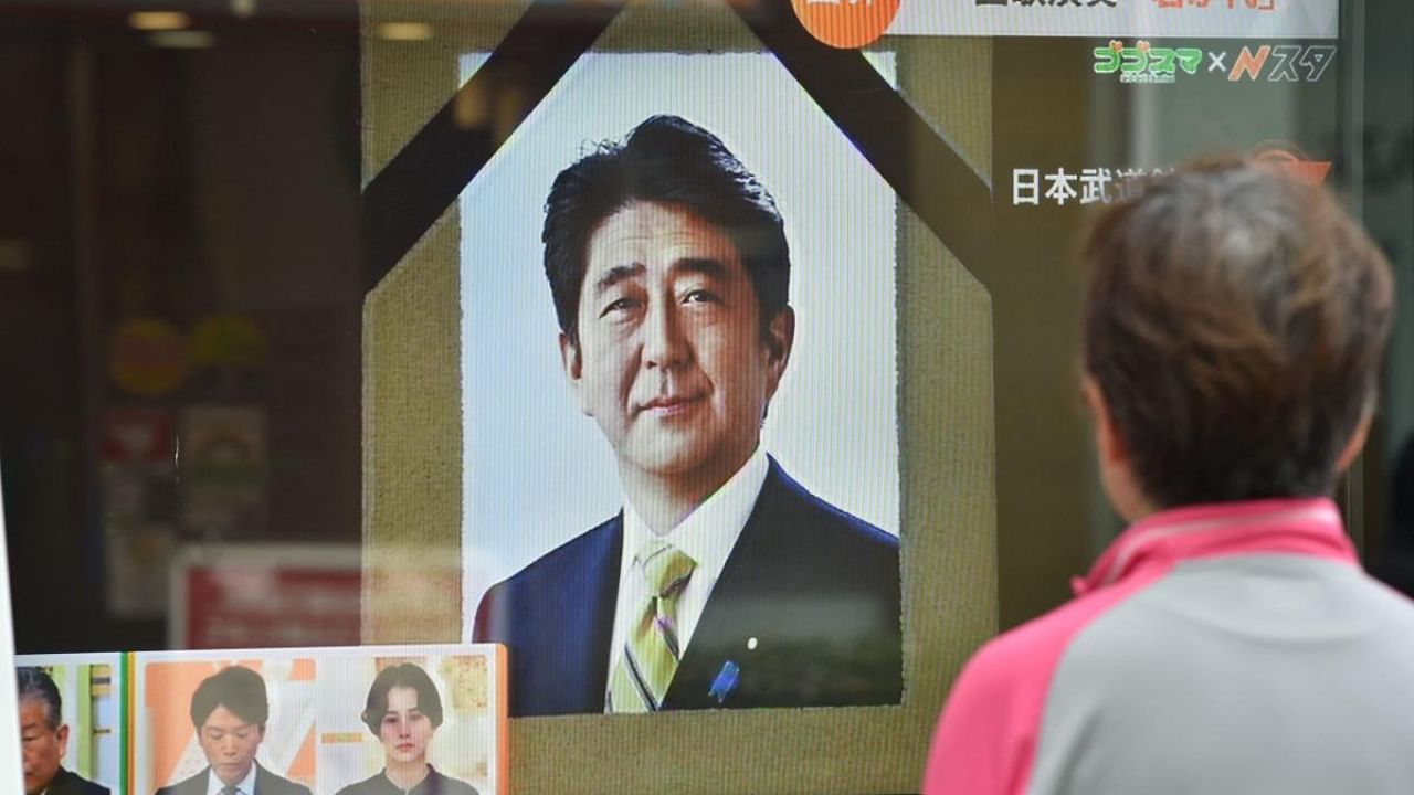 A woman watches a televised broadcast of the state funeral for Japan's former prime minister Shinzo Abe at the Nippon Budokan in Tokyo on September 27, 2022. Credit: AFP Photo