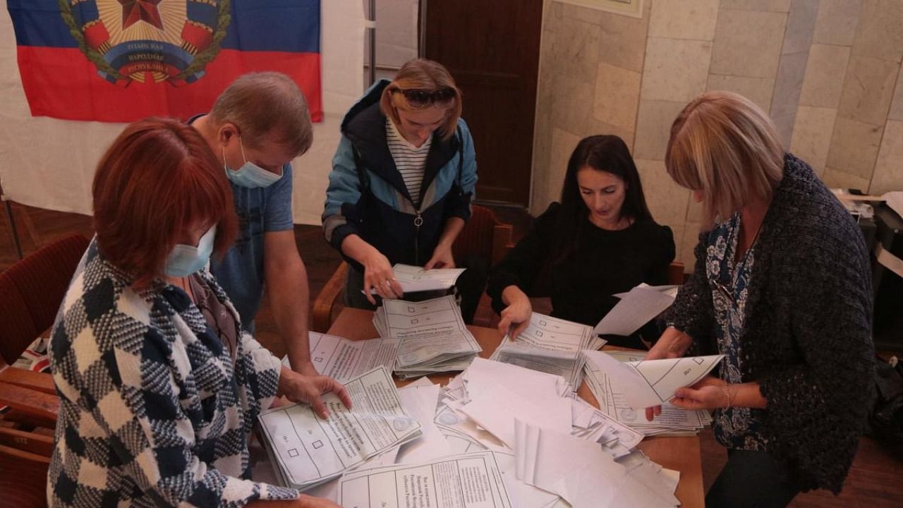 Election commission members count votes of refugees from Russian-held regions of Ukraine for a referendum at a polling station in Simferopol, Crimea. Credit: AFP Photo