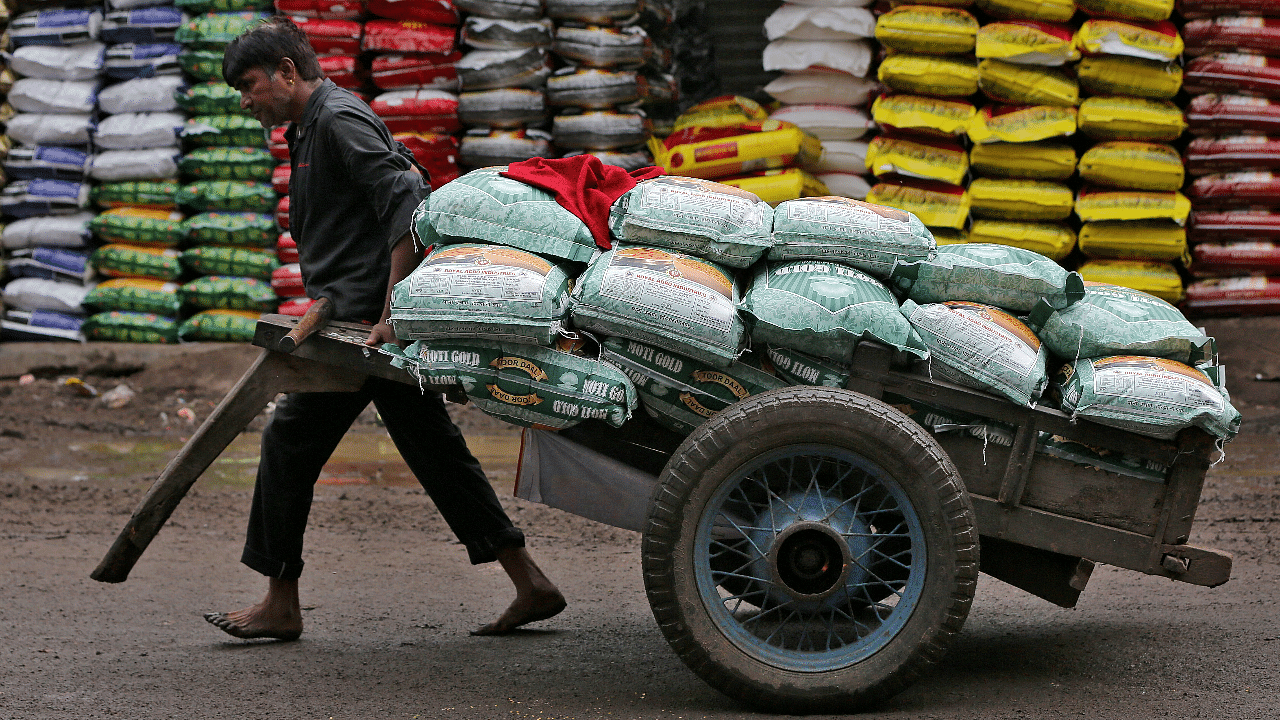 Five kilograms of wheat or rice is given free to over 80 crore India's poor through the scheme which costs the exchequer about Rs 1.5 lakh crore per annum. Credit: Reuters File Photo