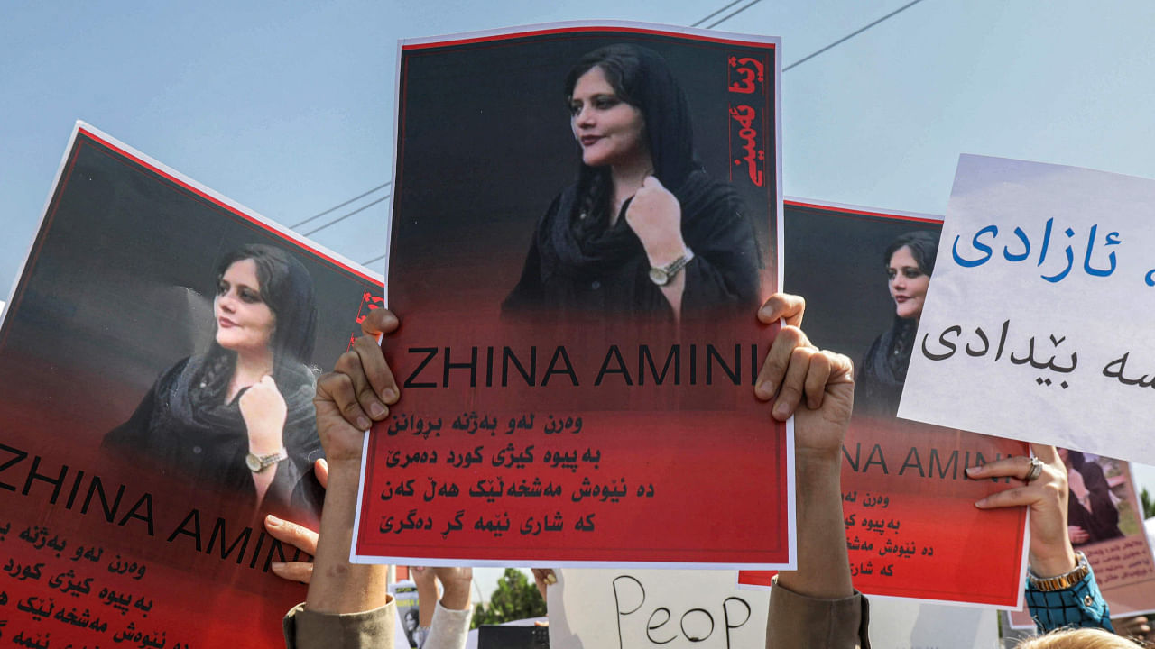 Women chant slogans and hold up signs depicting the image of 22-year-old Mahsa Amini, who died while in the custody of Iranian authorities. Credit: AFP Photo