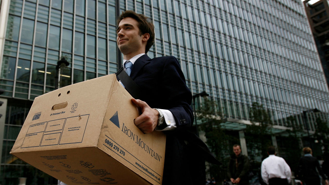 A worker carries a box out of the U.S. investment bank Lehman Brothers offices in the Canary Wharf district of London in this September 15, 2008. Credit: Reuters File Photo