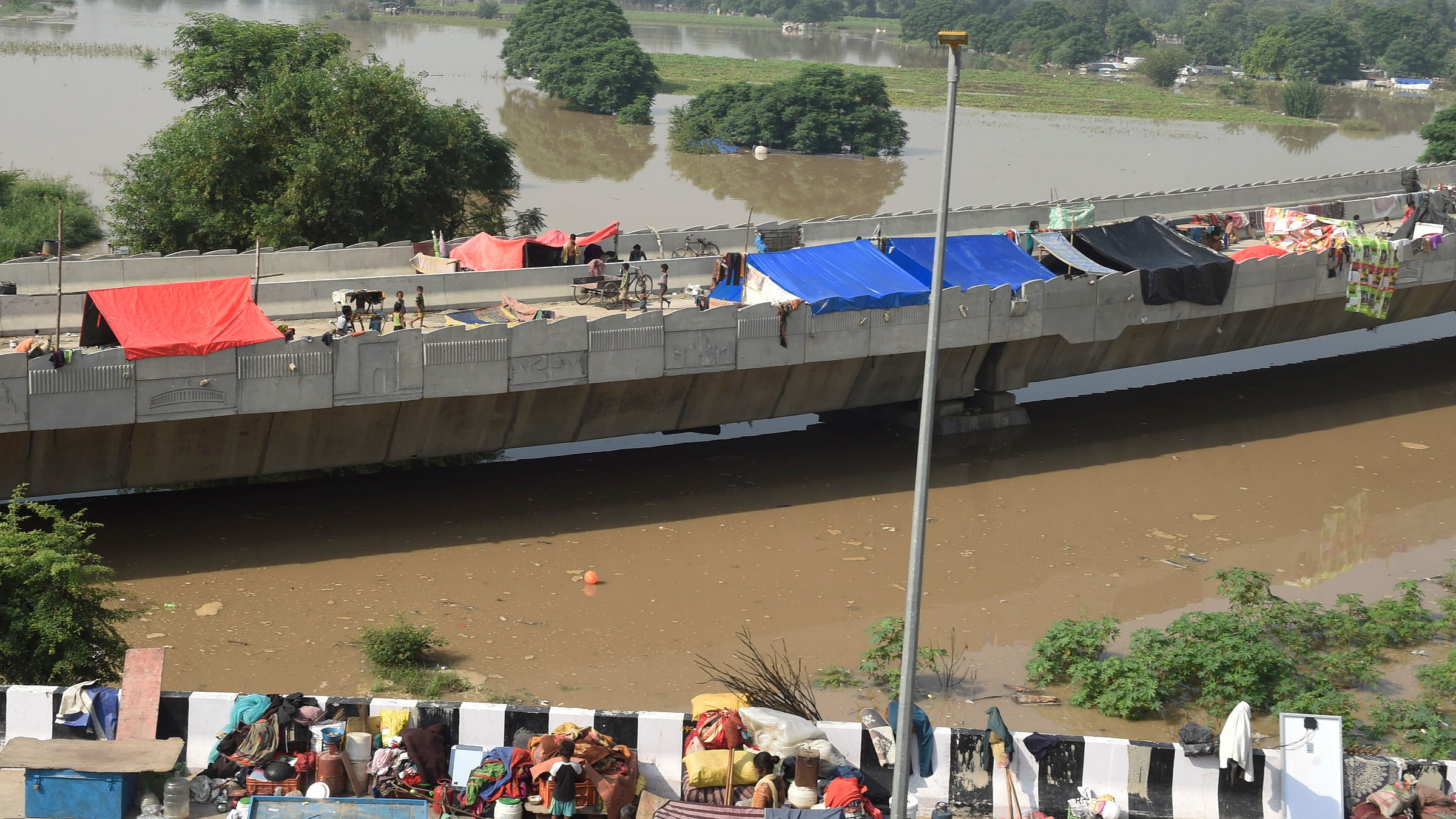 This is the second time within two months that the authorities are evacuating the people living in the river floodplains due to flooding in the low-lying areas. Credit: PTI Photo