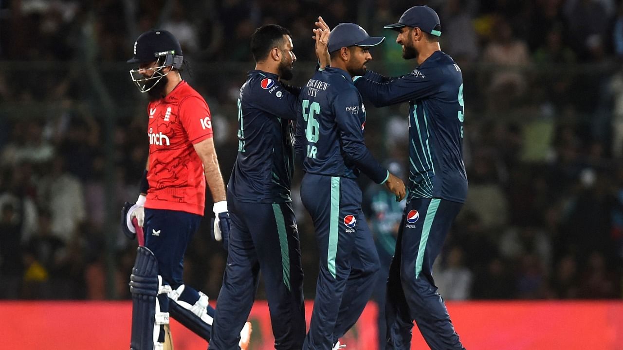 Pakistan's players celebrate after the dismissal of England's captain Moeen Ali (L) during the fourth Twenty20 international cricket match between Pakistan and England at the National Cricket Stadium in Karachi. Credit: AFP Photo