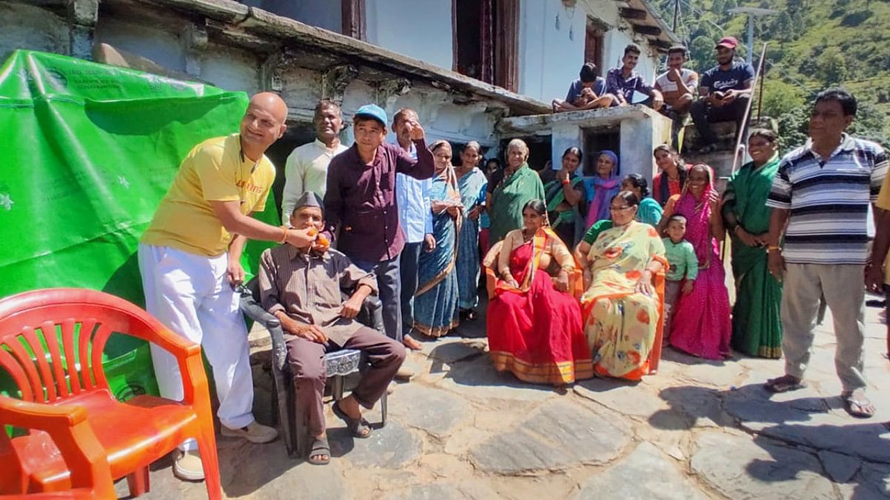 Family members of Chief of Defence Staff Lt Gen Anil Chauhan celebrate the news of his appointment at his ancestral village Gawana, in Pauri Garhwal district. Credit: PTI Photo