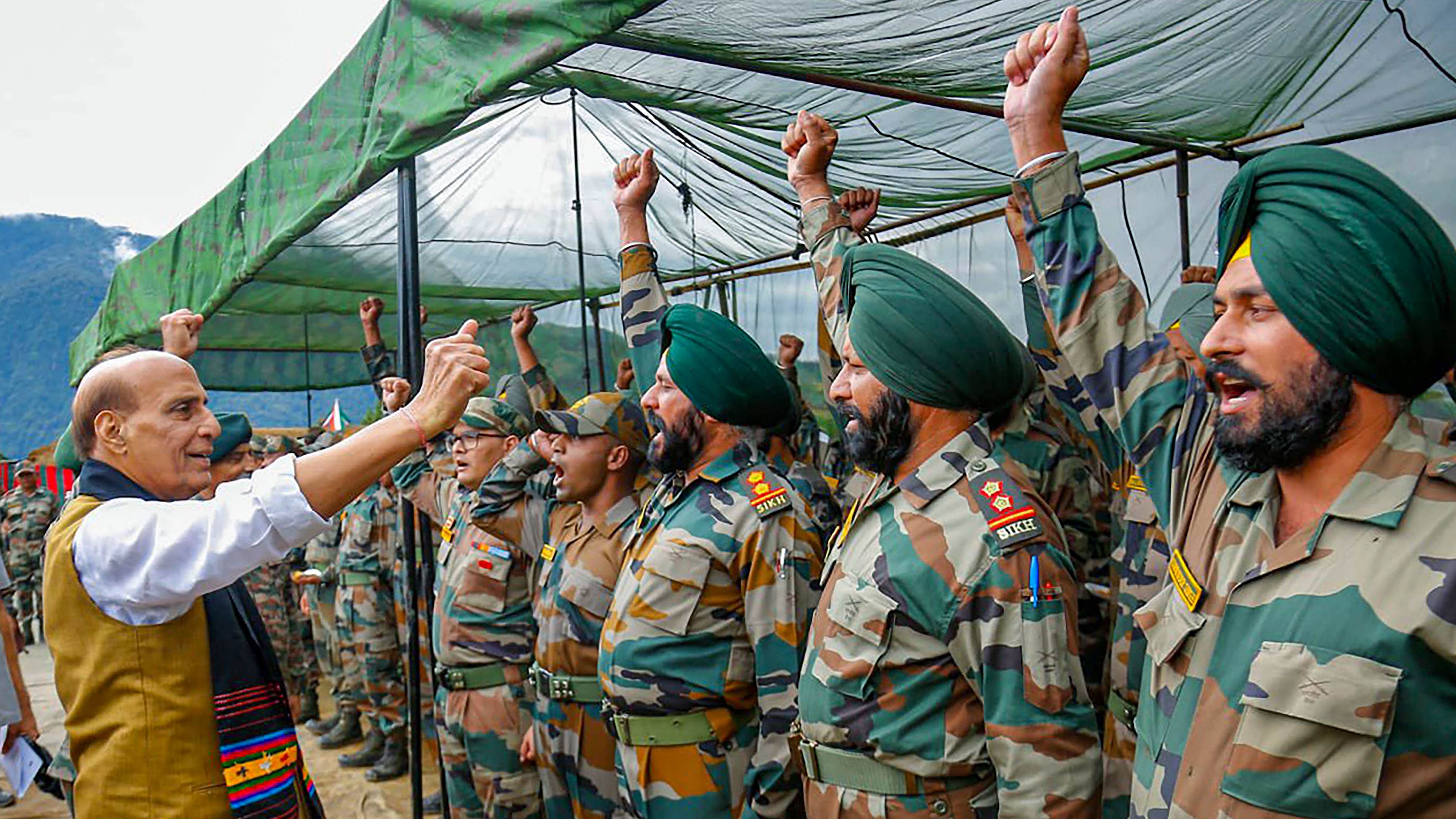 Rajnath Singh raises slogans with troops during his visit to forward areas in Dibang valley. Credit: PTI Photo