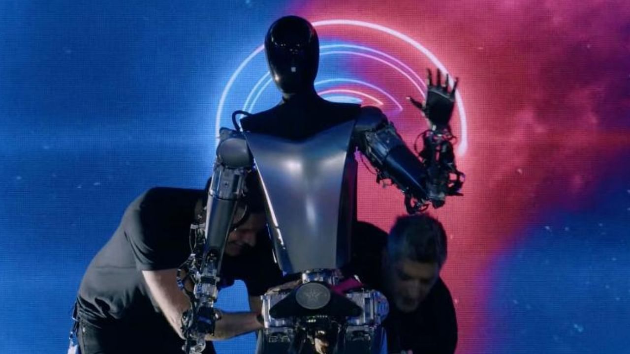 This video screen grab made from Tesla AI Day 2022 livestream shows staff bringing Optimus the humanoid robot, on stage in Palo Alto, California on September 30, 2022. Credit: AFP Photo