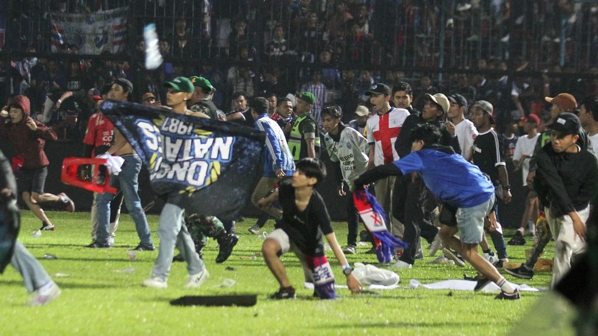 The disaster happened when fans of Arema FC stormed the pitch at the Kanjuruhan stadium after their team lost 3-2 to bitter rivals, Persebaya Surabaya. Credit: Reuters Photo