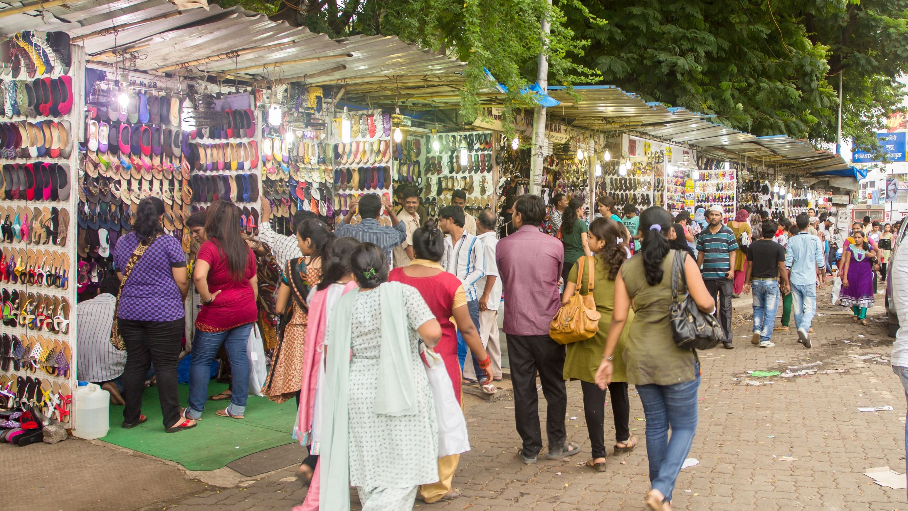 People throng sidewalk stores selling footwear in the Bandra suburb of Mumbai, India. Credit: Getty Images