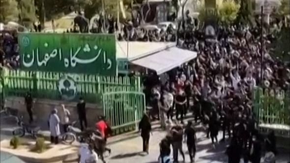This grab taken from a UGC video posted online on October 2, 2022 shows Iranian students attempting to open the entrance gate at the University of Isfahan in the Islamic republic's central city. Credit: AFP Photo