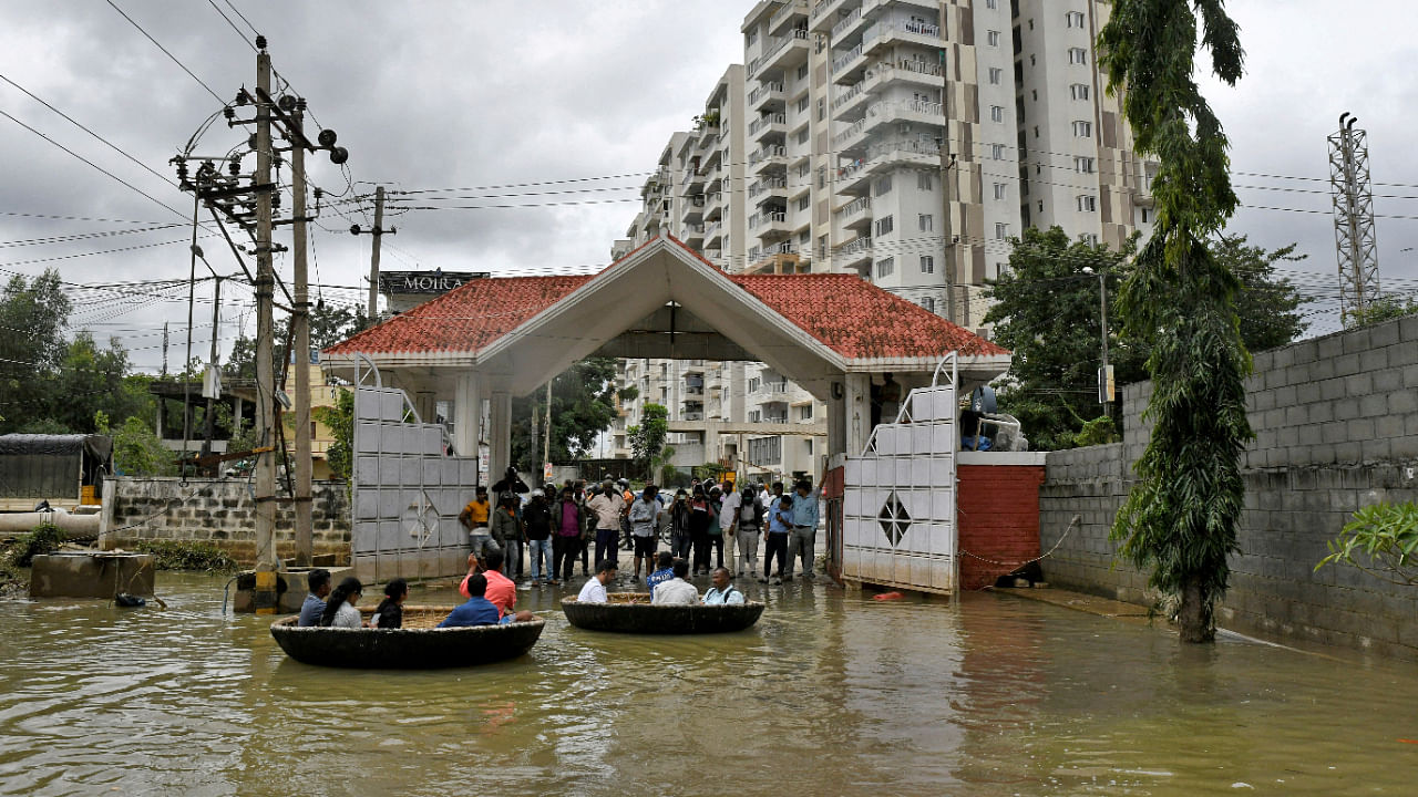 People use Coracle boats to move through a water-logged neighbourhood following torrential rains in Bengaluru, India, September 7, 2022. Credit: Reuters File Photo