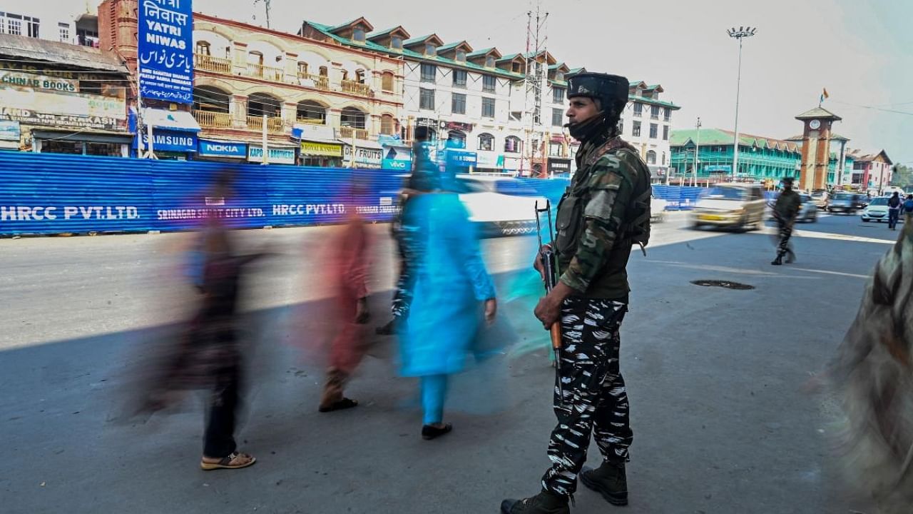 An Indian paramilitary trooper stands guard along a street in Srinagar ahead of Amit Shah's visit. Credit: AFP Photo