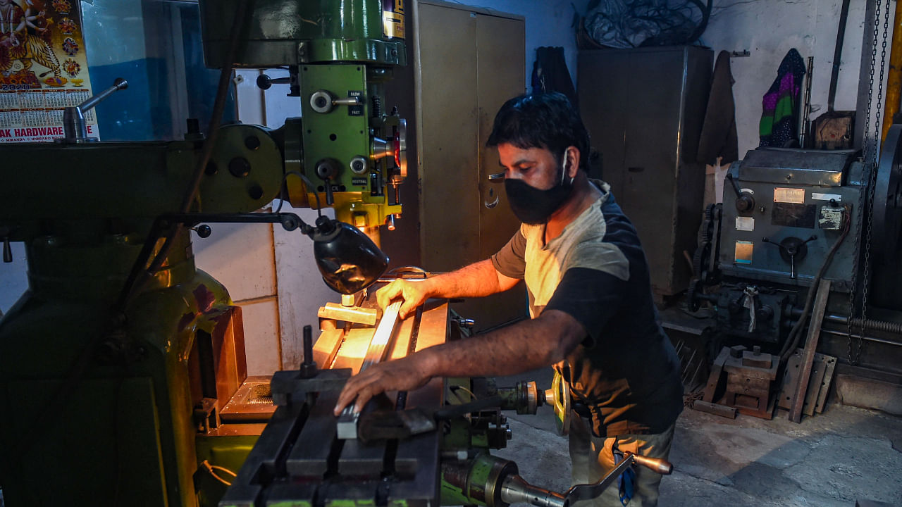 A worker busy at a factory in the Wazirpur Industrial area as the unlocking process of Covid-19 lockdown begins, in New Delhi, Monday, May 31, 2021. Credit: PTI File Photo