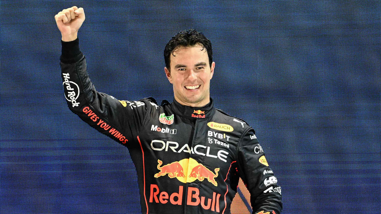Winner Red Bull Racing's Mexican driver Sergio Perez celebrates on the podium after the Formula One Singapore Grand Prix night race at the Marina Bay Street Circuit in Singapore on October 2, 2022. Credit: AFP Photo