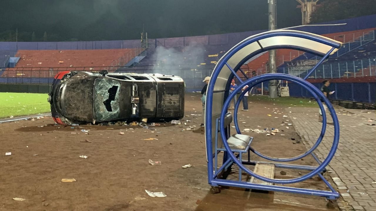 A damaged car is pictured following a riot after the league BRI Liga 1 football match between Arema vs Persebaya at Kanjuruhan Stadium, Malang, East Java province, Indonesia, October 2, 2022, in this photo taken by Antara Foto. Credit: Reuters Photo