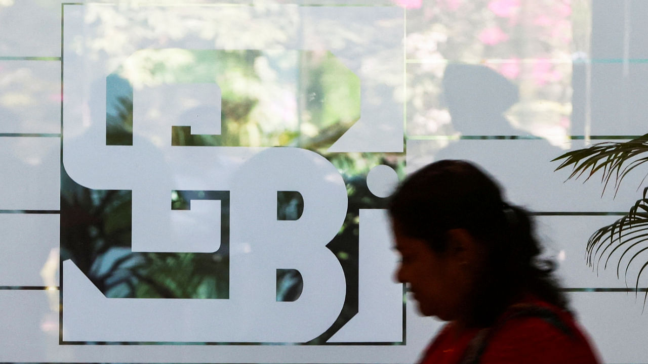 A woman walks past the logo of the Securities and Exchange Board of India (SEBI), at its headquarters in Mumbai, India, May 27, 2022. Credit: Reuters File Photo
