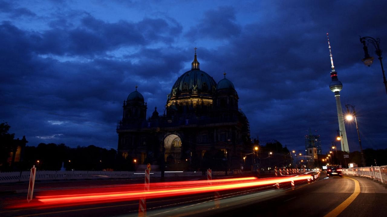 The Television Tower glows at dusk next to the Protestant Berlin Cathedral with a reduced lighting to save energy due to Russia's invasion of Ukraine in Berlin, Germany August 5, 2022. Credit: Reuters Photo
