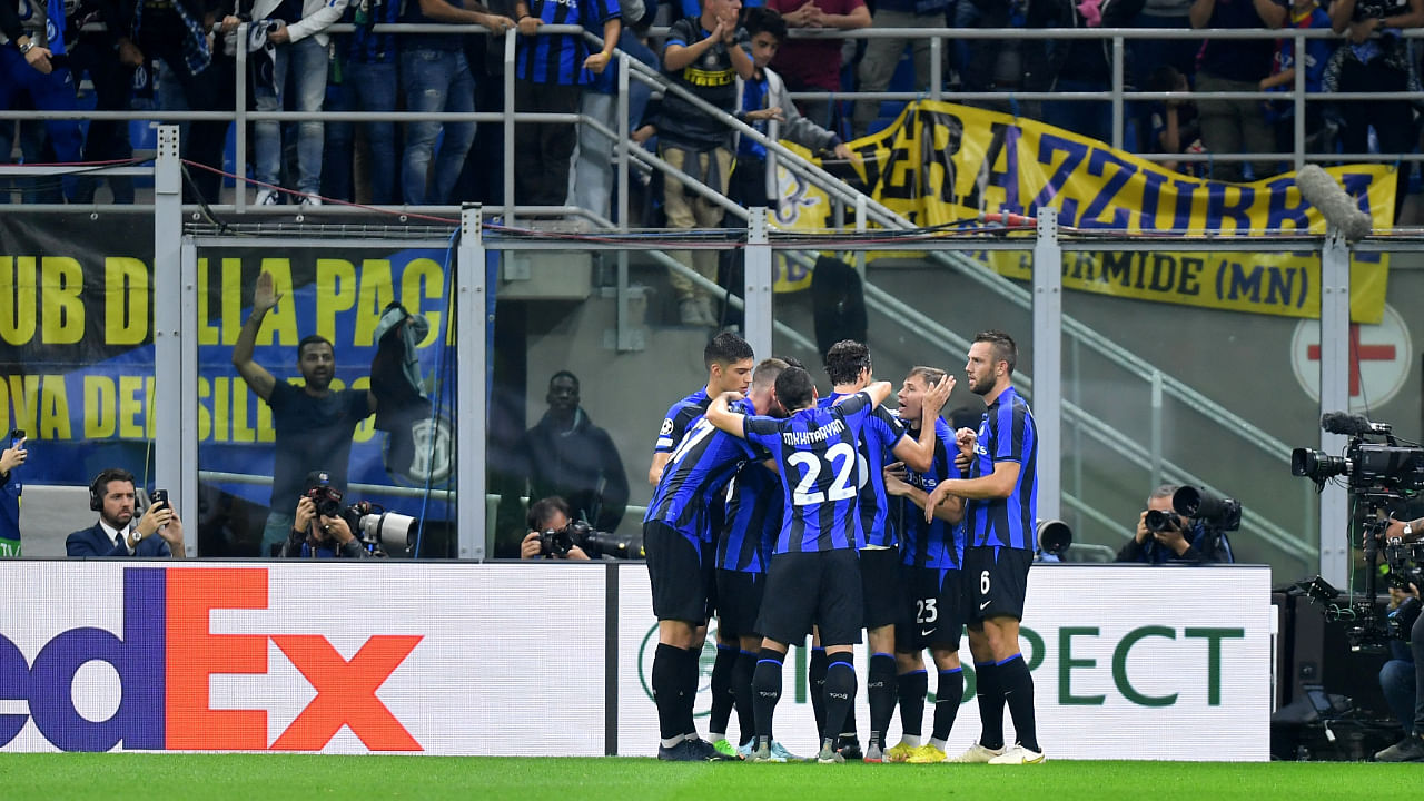 Inter Milan's Hakan Calhanoglu celebrates scoring their first goal with teammates. Credit: Reuters Photo