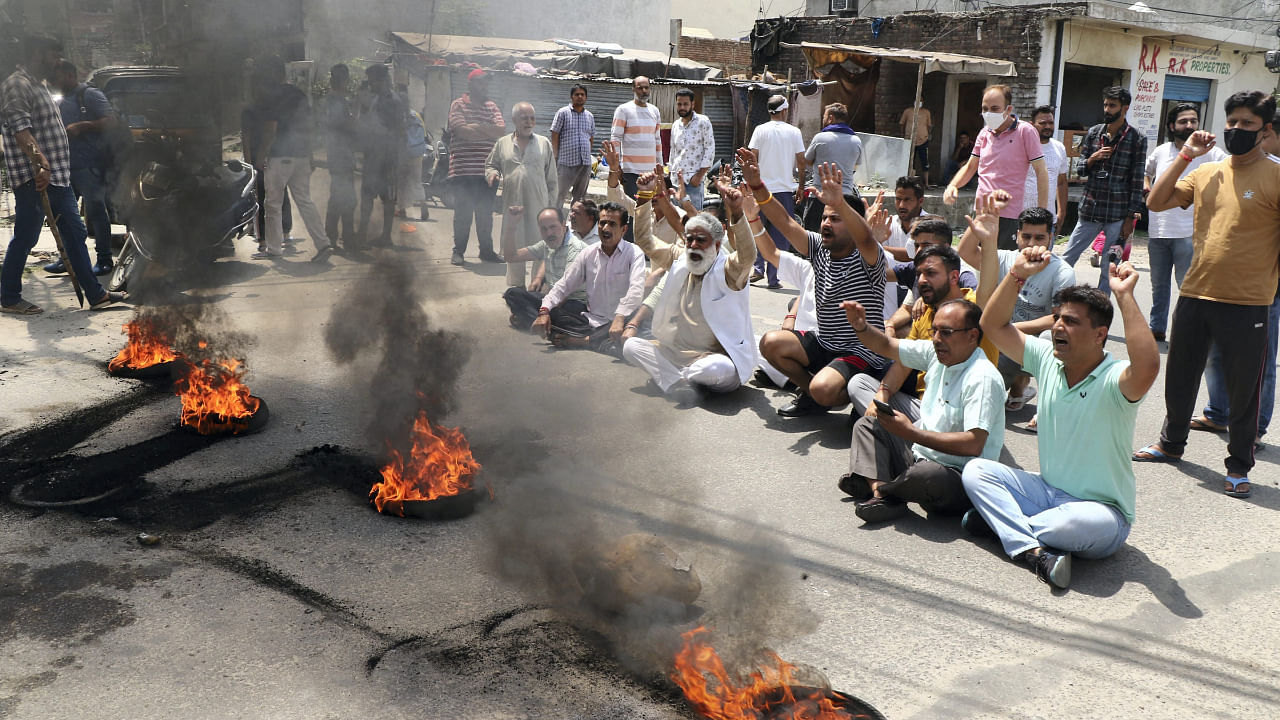 Kashmiri Pandits raise slogans over the killing of a government employee, in Jammu, May 13, 2022. The victim was shot at by militants inside his office and later succumbed to injury. Credit: PTI Photo