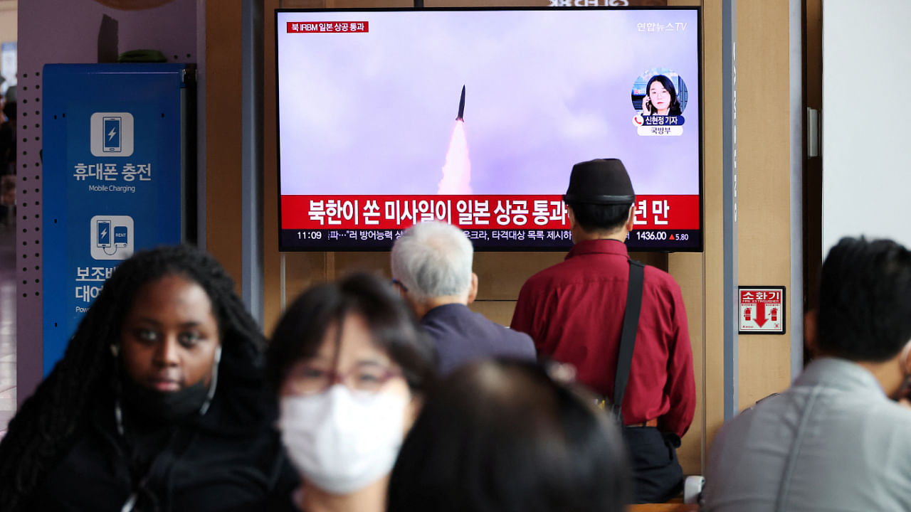 People watch a TV broadcasting a news report on North Korea firing a ballistic missile over Japan, at a railway station in Seoul, South Korea, October 4, 2022. Credit: Reuters Photo