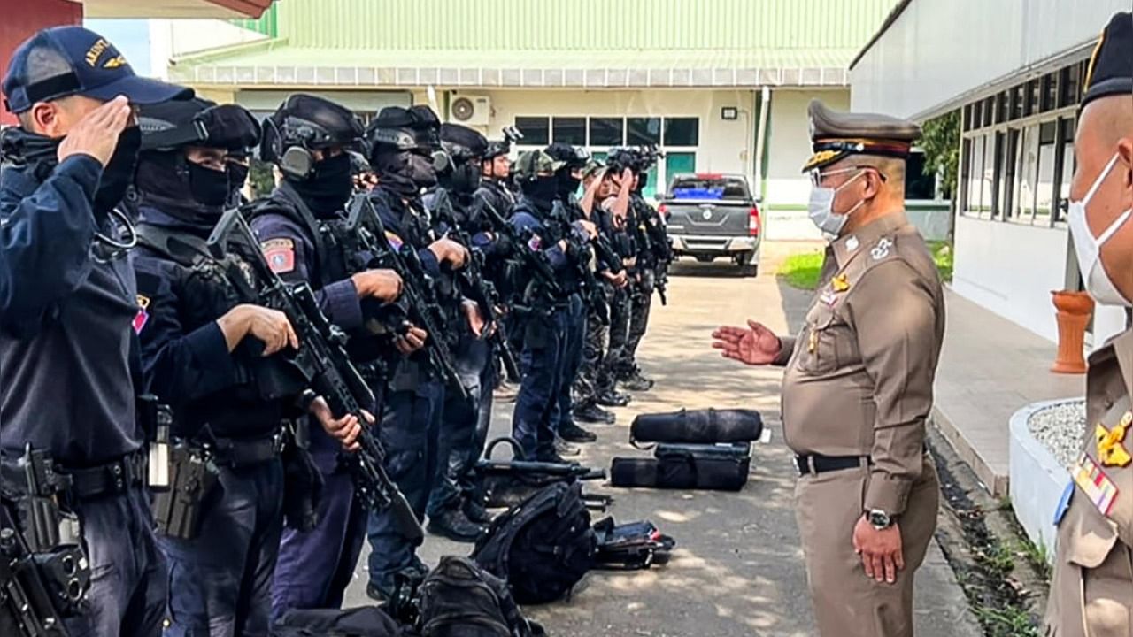 This handout picture taken and released by the Royal Thai Police on October 6, 2022 shows National Police Chief, Damrongsak Kittiprapat (2R), speaking with a police operation team in the northern Thai province of Nong Bua Lam Phu following an attack on a nursery. Credit: AFP Photo