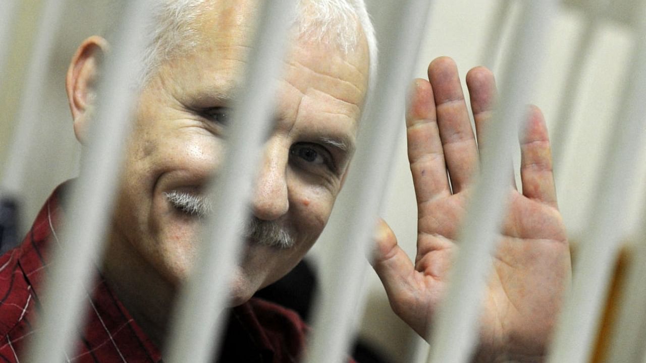 A photo taken through the bars of the defendant’s cage shows Ales Beliatsky, in a court in Minsk. Credit: AFP File Photo