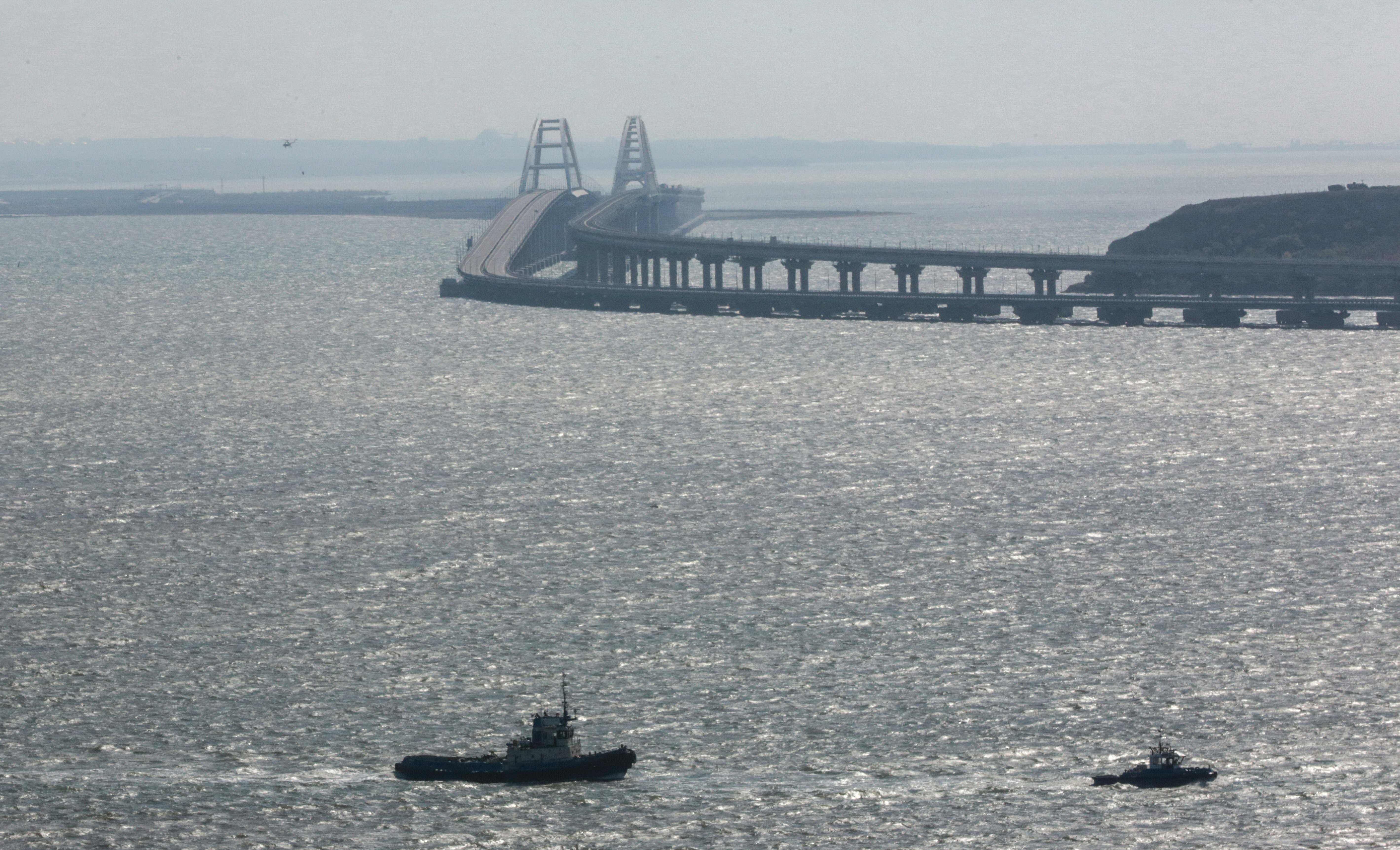 This photograph taken on October 8, 2022 shows the Kerch bridge that links Crimea to Russia after a truck exploaded on the bridge this morning in Kerch. Credit: AFP Photo