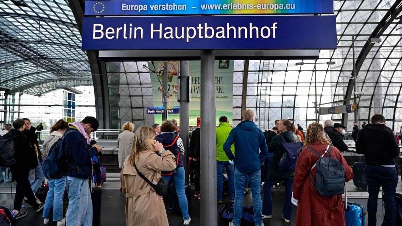Rail passengers wait for a train on a platform at the main train station in Berlin on Octomer 8, 2022 following major disruption on the German railway network. Credit: AFP Photo