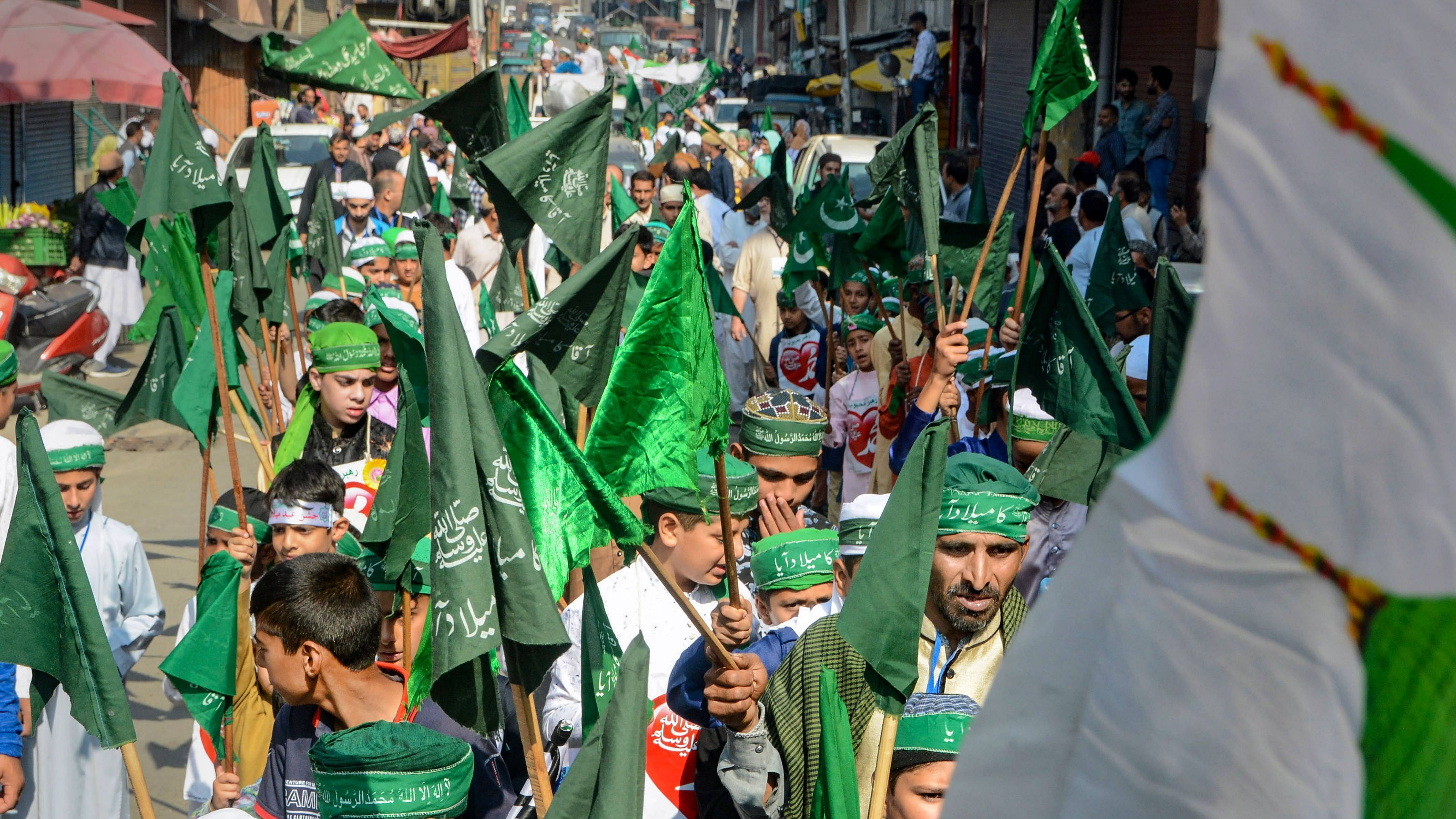Boys carrying religious flags take part in Eid-e-Milad-un-Nabi procession in Srinagar. Credit: PTI Photo