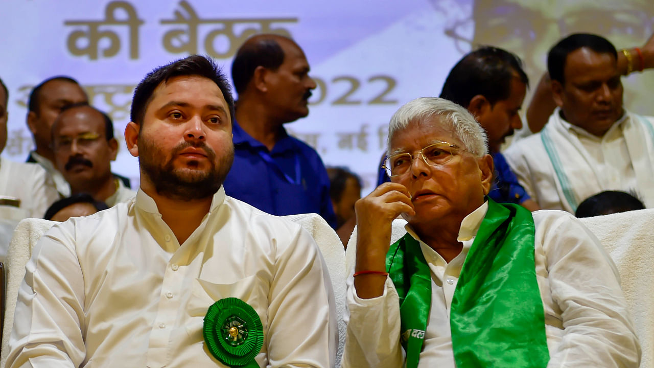 RJD chief Lalu Prasad with party leader Tejashwi Yadav during the party's national executive meeting, in New Delhi, Sunday, Oct. 9, 2022. Credit: PTI Photo