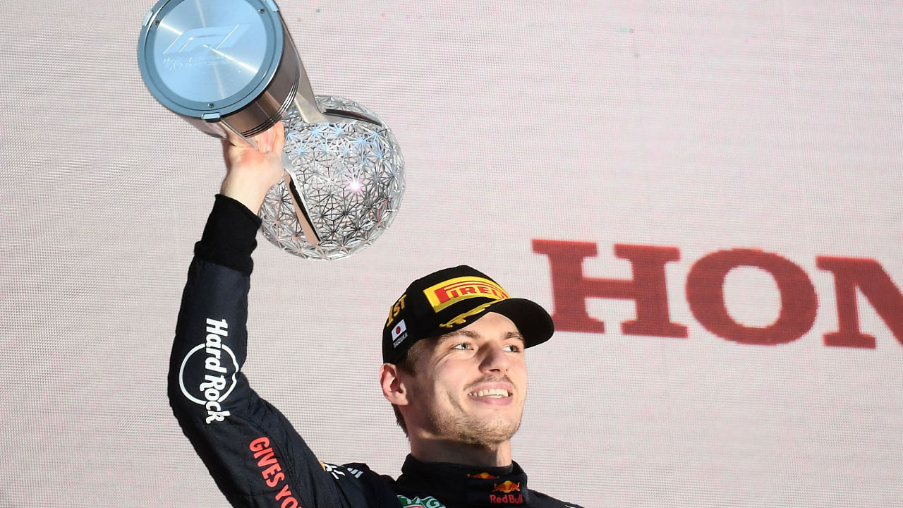 Red Bull Racing's Dutch driver Max Verstappen poses on the podium with the trophy following his victory at the Formula One Japanese Grand Prix at Suzuka, Mie prefecture on October 9, 2022. Credit: AFP Photo